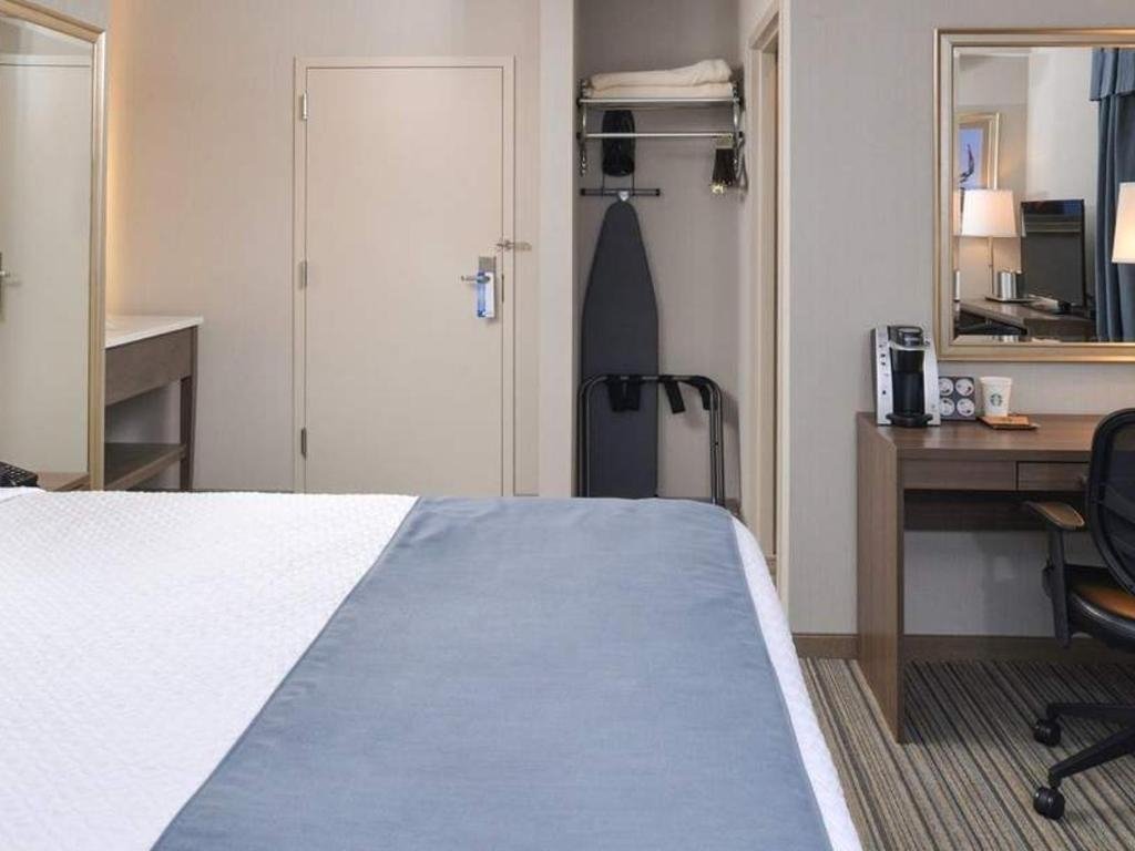 Bed and ironing board in closet