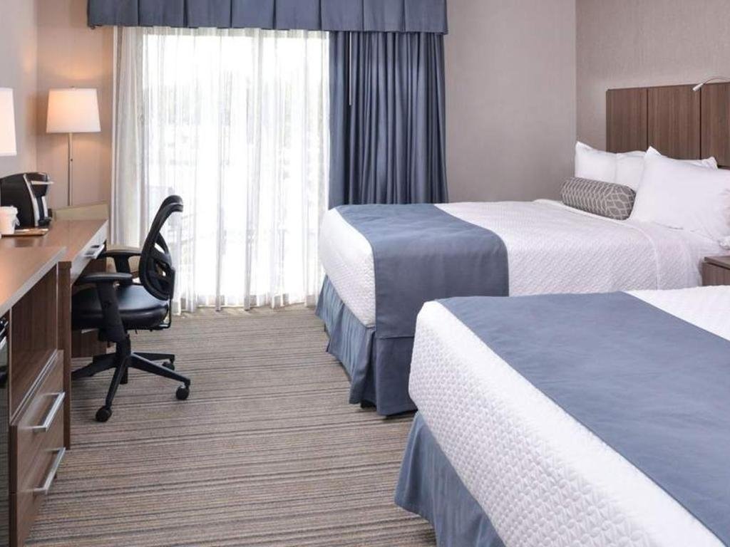 Desk with chair in a room with two beds